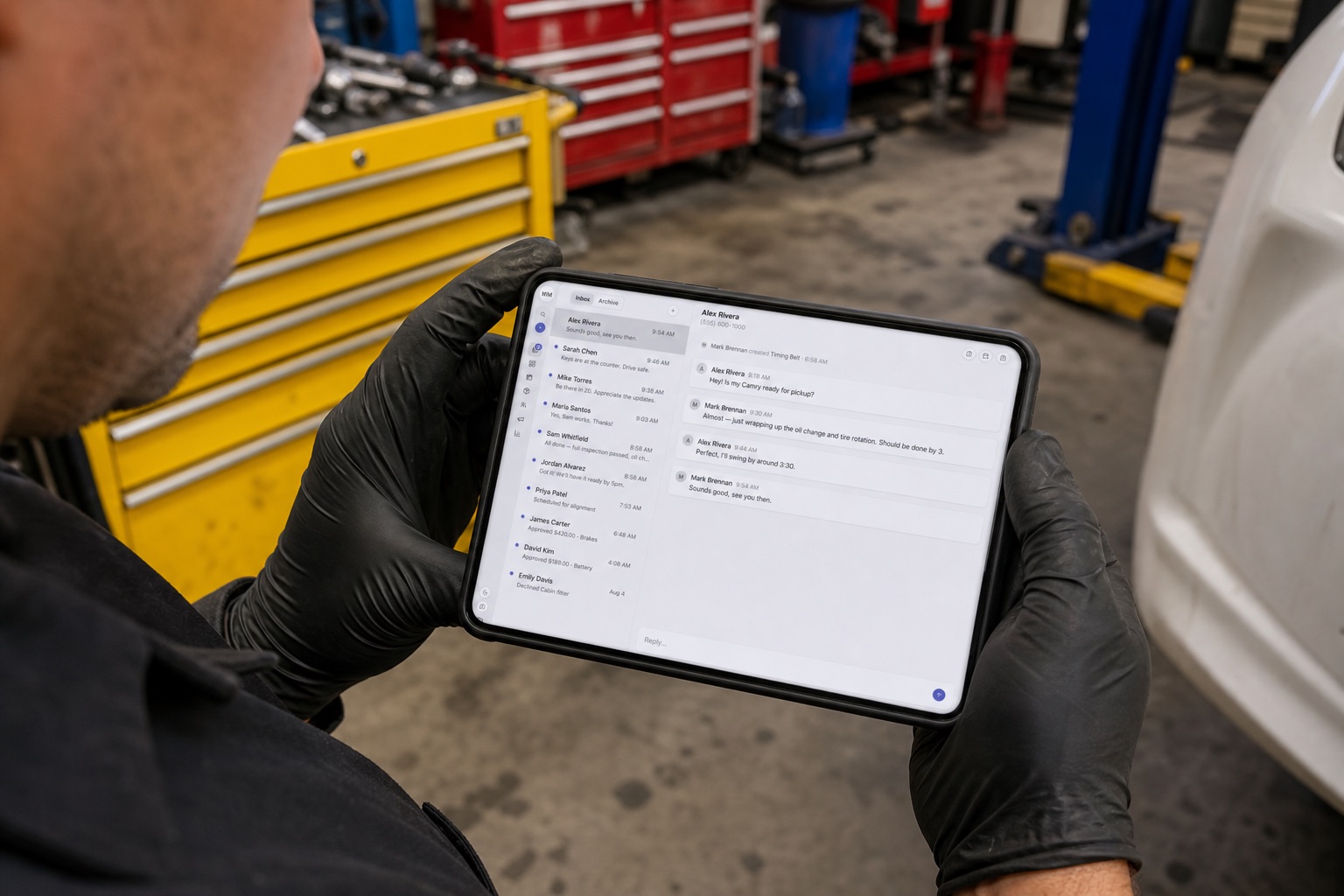 Technician in the bay reading a customer thread about a Camry oil change